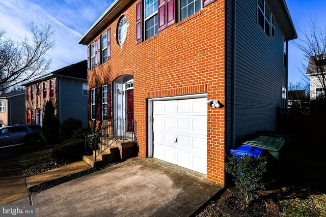3313 Cornwell Dr SE, Washington, DC 20032 - view of side of property with a garage, brick siding, and driveway
