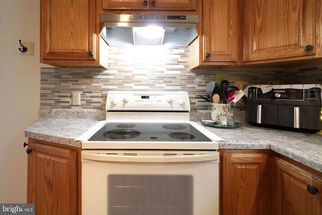 503 N Rachels Way, Aaronsburg, PA 16820 - kitchen featuring white range with electric stovetop, under cabinet range hood, light countertops, and decorative backsplash