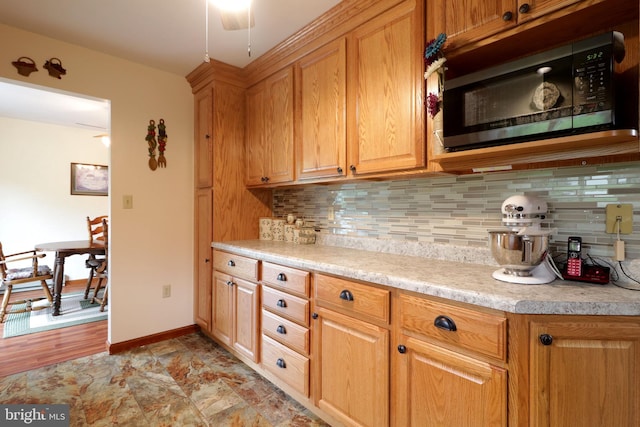 503 N Rachels Way, Aaronsburg, PA 16820 - kitchen featuring black microwave, decorative backsplash, light countertops, baseboards, and ceiling fan