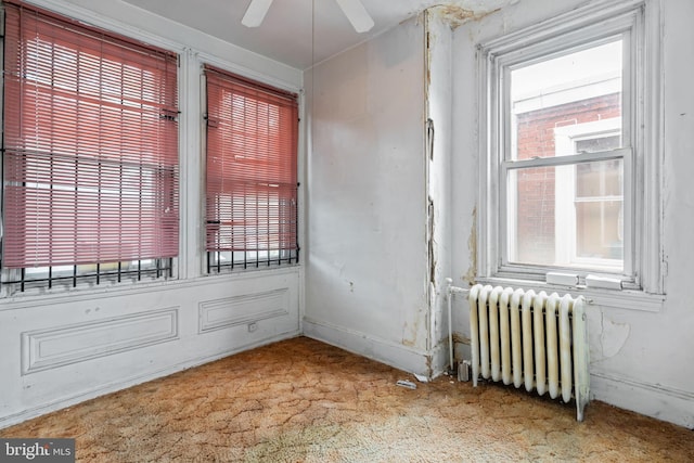 2531 N Lawrence St, Philadelphia, PA 19133 - empty room with radiator, carpet floors, plenty of natural light, and a ceiling fan