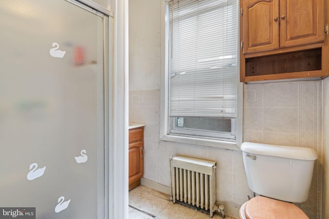 2531 N Lawrence St, Philadelphia, PA 19133 - full bath with radiator heating unit, tile walls, toilet, vanity, and a stall shower