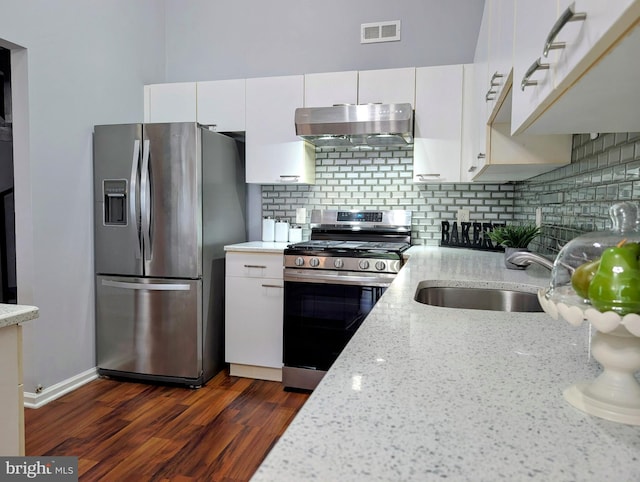 407 Talon Ct, Lawrence, NJ 08648 - kitchen with stainless steel appliances, under cabinet range hood, white cabinetry, tasteful backsplash, and dark wood-style floors