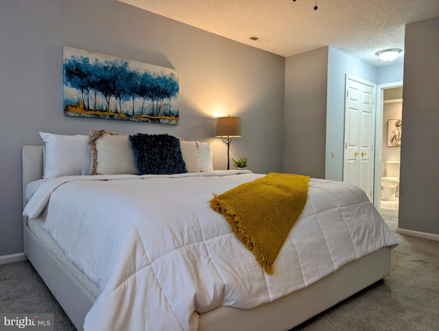 407 Talon Ct, Lawrence, NJ 08648 - carpeted bedroom with baseboards, ensuite bathroom, and a textured ceiling