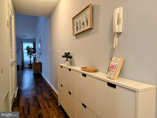 407 Talon Ct, Lawrence, NJ 08648 - hall featuring dark wood finished floors, a textured ceiling, and baseboards