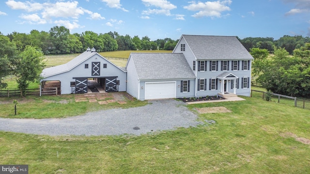 11966 Bluegrass Ct, Nokesville, VA 20181 - colonial-style house with gravel driveway, roof with shingles, a garage, and a barn