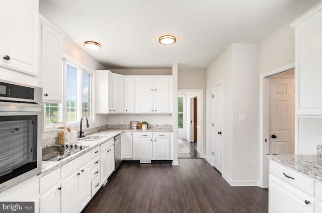 11966 Bluegrass Ct, Nokesville, VA 20181 - kitchen with stainless steel appliances, a sink, dark wood finished floors, and white cabinets