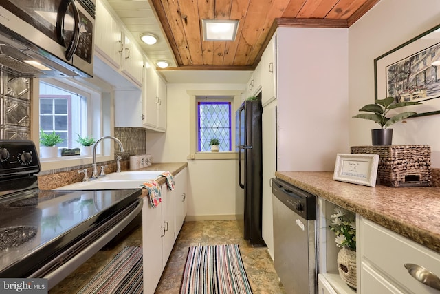 302 6th St, Mount Gretna, PA 17064 - kitchen featuring appliances with stainless steel finishes, wood ceiling, a sink, white cabinets, and stone finish floors