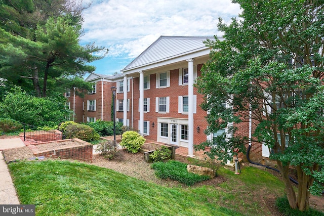7621 Tremayne Pl Unit 205, Mclean, VA 22102 - greek revival house featuring brick siding and a front lawn