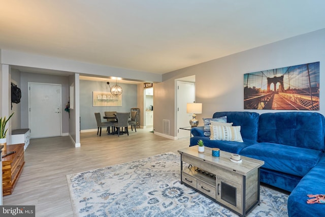 7621 Tremayne Pl Unit 205, Mclean, VA 22102 - living area featuring light wood finished floors, a chandelier, and baseboards