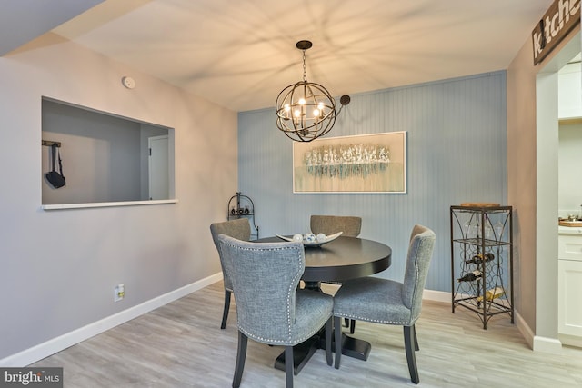 7621 Tremayne Pl Unit 205, Mclean, VA 22102 - dining space featuring a chandelier, wood finished floors, and baseboards