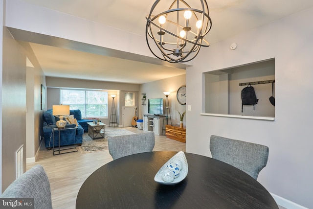 7621 Tremayne Pl Unit 205, Mclean, VA 22102 - dining room featuring a chandelier, wood finished floors, and baseboards