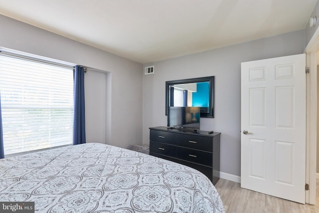 7621 Tremayne Pl Unit 205, Mclean, VA 22102 - bedroom featuring multiple windows, light wood finished floors, and baseboards