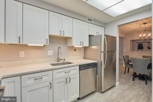 7621 Tremayne Pl Unit 205, Mclean, VA 22102 - kitchen with stainless steel appliances, a sink, light wood-style flooring, and white cabinets