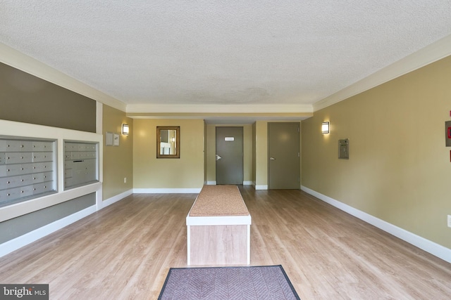 7621 Tremayne Pl Unit 205, Mclean, VA 22102 - entryway with a textured ceiling, mail area, light wood-style flooring, crown molding, and baseboards