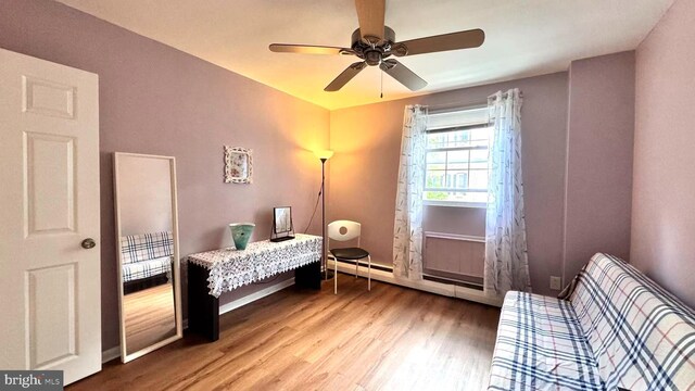 207 Walnut Hill Rd Unit B17, West Chester, PA 19382 - bedroom featuring a baseboard radiator, light wood finished floors, and ceiling fan