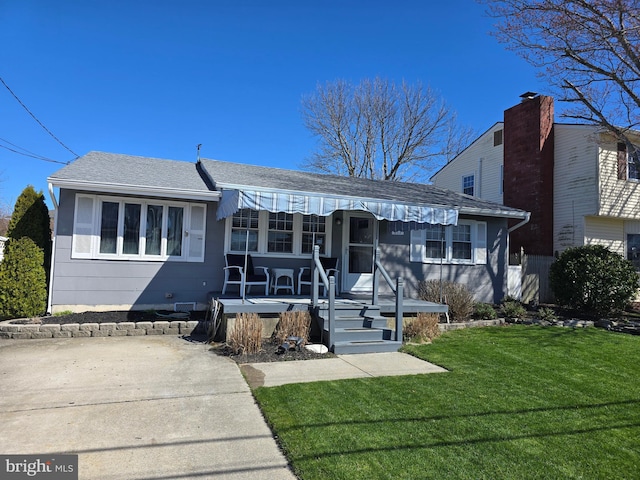 817 Lafayette Blvd, Brigantine, NJ 08203 - view of front of home with a front yard, a shingled roof, and a porch
