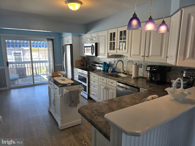 817 Lafayette Blvd, Brigantine, NJ 08203 - kitchen featuring stainless steel appliances, a sink, dark wood finished floors, a kitchen island, and decorative backsplash