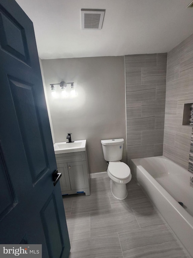 901 N Luzerne Ave, Baltimore, MD 21205 - bathroom with vanity, toilet, a tub, baseboards, and tile patterned floors