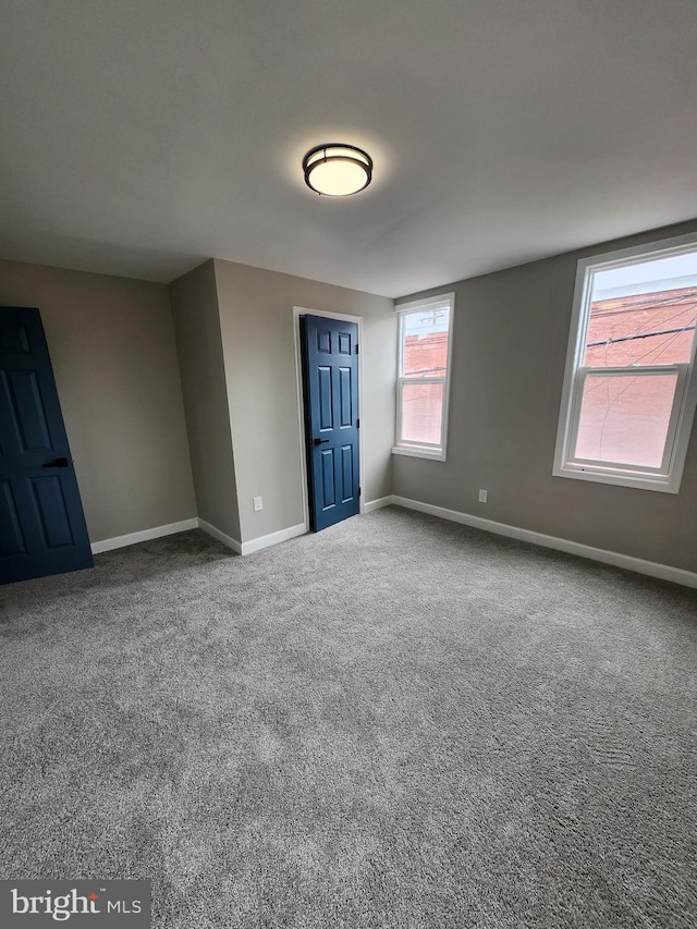 901 N Luzerne Ave, Baltimore, MD 21205 - carpeted empty room with baseboards