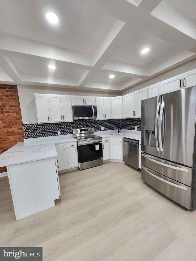 901 N Luzerne Ave, Baltimore, MD 21205 - kitchen featuring appliances with stainless steel finishes, light stone countertops, tasteful backsplash, a peninsula, and coffered ceiling