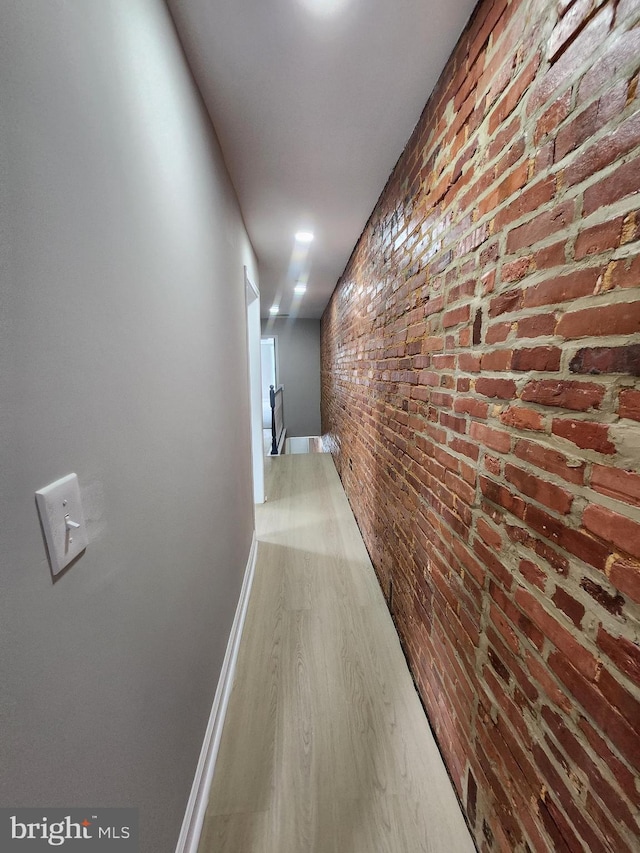 901 N Luzerne Ave, Baltimore, MD 21205 - hall featuring wood finished floors, brick wall, and baseboards