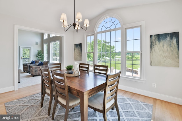16328 Limestone Ct, Leesburg, VA 20176 - dining space with light wood-style flooring, baseboards, a chandelier, and lofted ceiling
