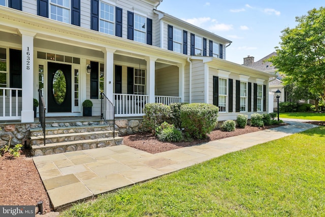 16328 Limestone Ct, Leesburg, VA 20176 - view of exterior entry featuring a porch and a lawn