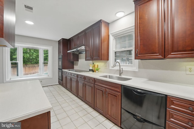 2624 Black Fir Ct, Reston, VA 20191 - kitchen with black appliances, a sink, light countertops, under cabinet range hood, and recessed lighting