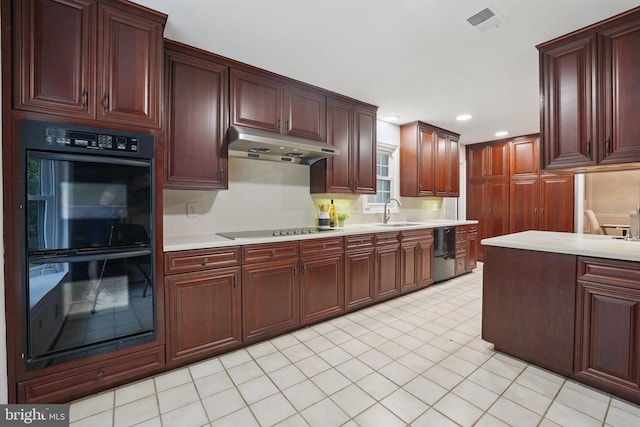 2624 Black Fir Ct, Reston, VA 20191 - kitchen featuring black appliances, under cabinet range hood, a sink, light countertops, and light tile patterned floors