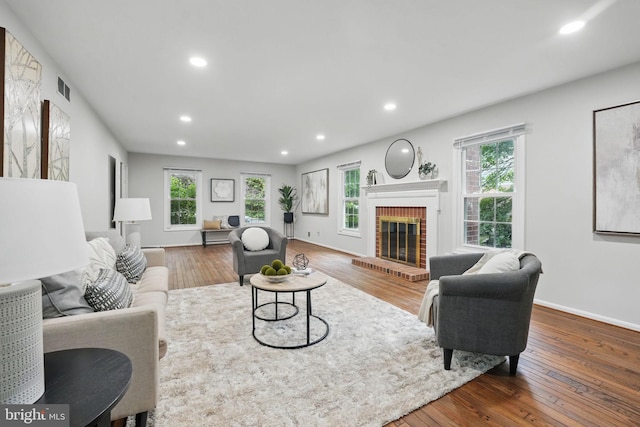 2624 Black Fir Ct, Reston, VA 20191 - living area with wood-type flooring, recessed lighting, plenty of natural light, a fireplace, and baseboards