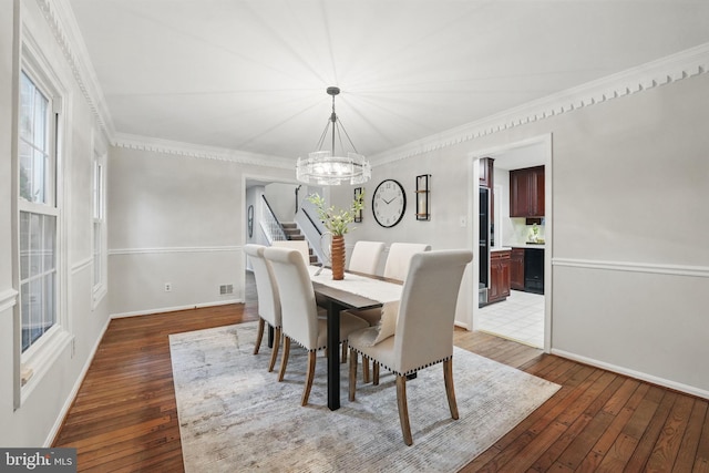 2624 Black Fir Ct, Reston, VA 20191 - dining area featuring a chandelier, hardwood / wood-style flooring, baseboards, and crown molding
