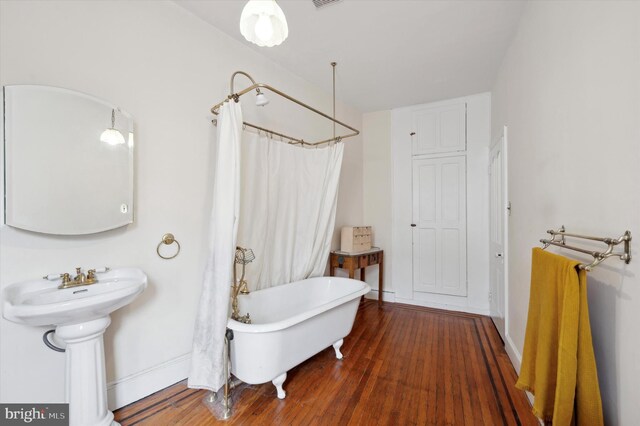 2347 E Norris St, Philadelphia, PA 19125 - bathroom featuring a freestanding bath, wood finished floors, baseboards, a shower with curtain, and a sink