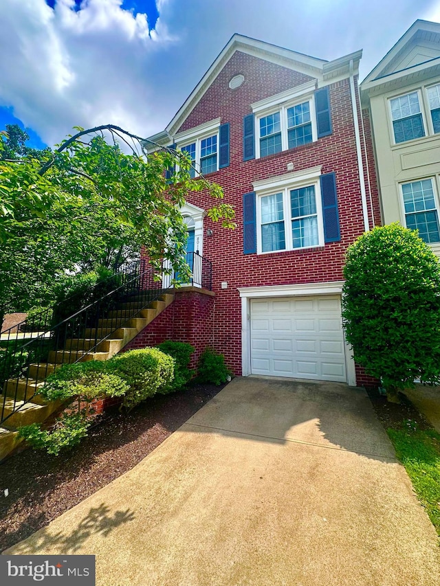 8011 Readington Ct, Springfield, VA 22152 - view of front facade featuring concrete driveway, an attached garage, brick siding, and stairway