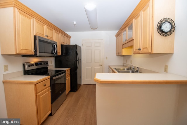 1103 S Schumaker Dr Unit C-201, Salisbury, MD 21804 - kitchen featuring appliances with stainless steel finishes, light brown cabinetry, light wood finished floors, a peninsula, and light countertops