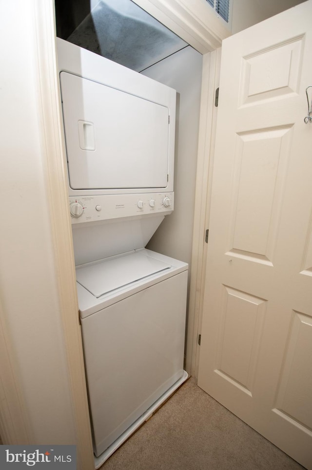 1103 S Schumaker Dr Unit C-201, Salisbury, MD 21804 - laundry room featuring stacked washer and clothes dryer and carpet flooring