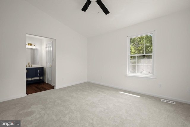 9439 Fens Holw, Laurel, MD 20723 - unfurnished bedroom with dark colored carpet, lofted ceiling, baseboards, and ensuite bath