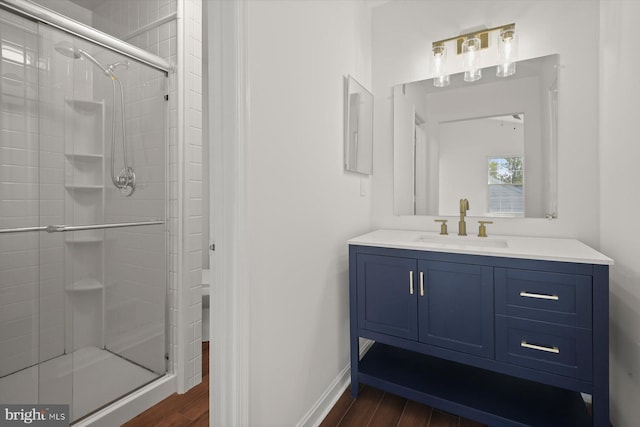 9439 Fens Holw, Laurel, MD 20723 - bathroom with a shower stall, wood finished floors, vanity, and baseboards