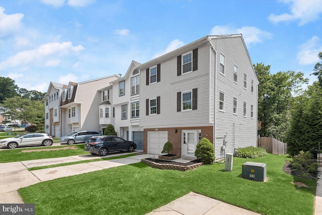 9439 Fens Holw, Laurel, MD 20723 - townhome / multi-family property featuring a garage, concrete driveway, and brick siding