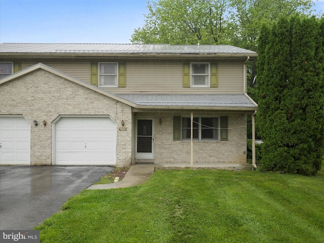 14754 Sherwood Dr, Greencastle, PA 17225 - traditional-style house featuring driveway, a front lawn, metal roof, brick siding, and covered porch