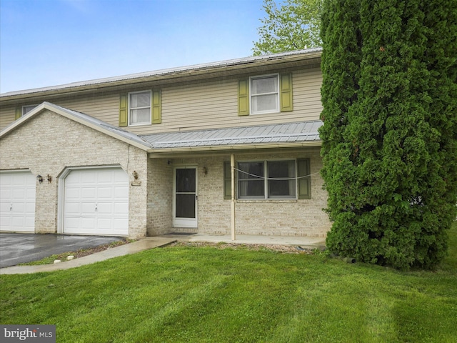 14754 Sherwood Dr, Greencastle, PA 17225 - traditional-style house with driveway, a front lawn, an attached garage, and metal roof