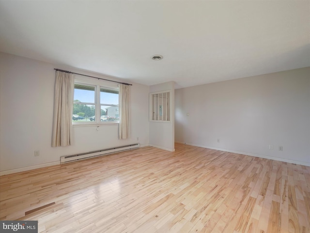 14754 Sherwood Dr, Greencastle, PA 17225 - spare room featuring baseboard heating, wood finished floors, and baseboards