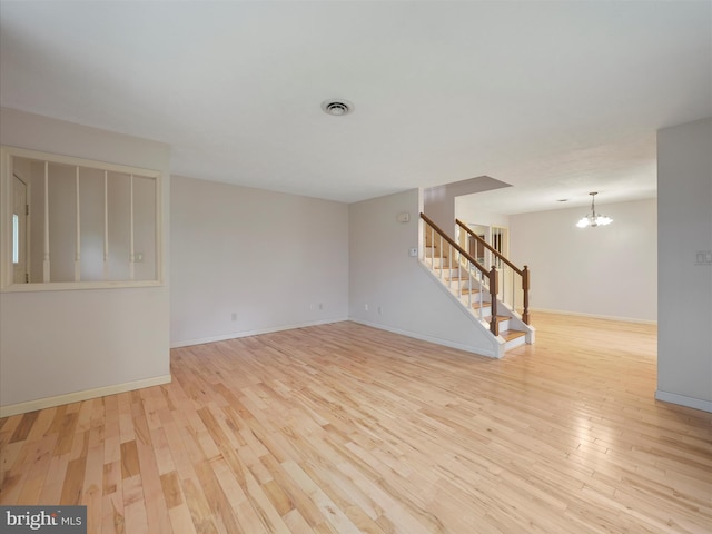 14754 Sherwood Dr, Greencastle, PA 17225 - unfurnished room featuring stairway, wood finished floors, a chandelier, and baseboards