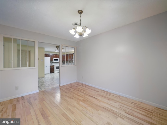 14754 Sherwood Dr, Greencastle, PA 17225 - spare room with a chandelier, light wood finished floors, baseboards, and ceiling fan