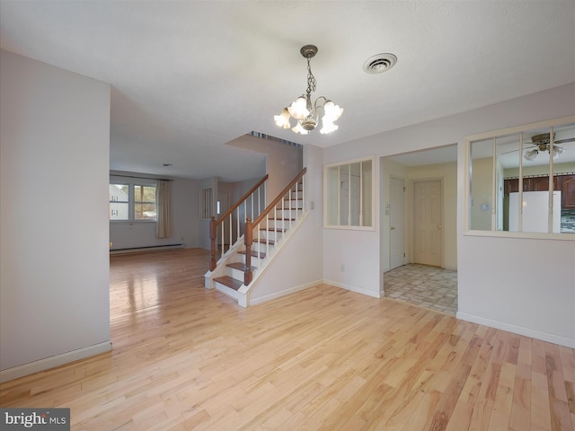 14754 Sherwood Dr, Greencastle, PA 17225 - empty room with wood finished floors, a chandelier, baseboard heating, stairway, and baseboards