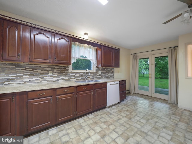 14754 Sherwood Dr, Greencastle, PA 17225 - kitchen featuring white dishwasher, a sink, ceiling fan, decorative backsplash, and stone finish flooring