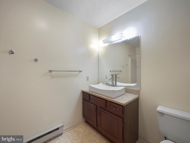 14754 Sherwood Dr, Greencastle, PA 17225 - bathroom with a baseboard heating unit, vanity, toilet, tile patterned floors, and baseboards