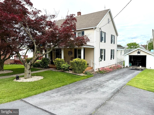 239 S Allison St, Greencastle, PA 17225 - view of front facade featuring an outdoor structure, a chimney, a front lawn, asphalt driveway, and a garage