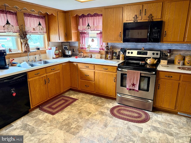 239 S Allison St, Greencastle, PA 17225 - kitchen featuring black appliances, a sink, light countertops, and plenty of natural light