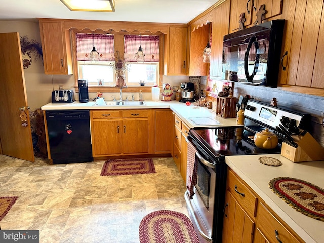 239 S Allison St, Greencastle, PA 17225 - kitchen with black appliances, a sink, light countertops, brown cabinetry, and stone finish flooring