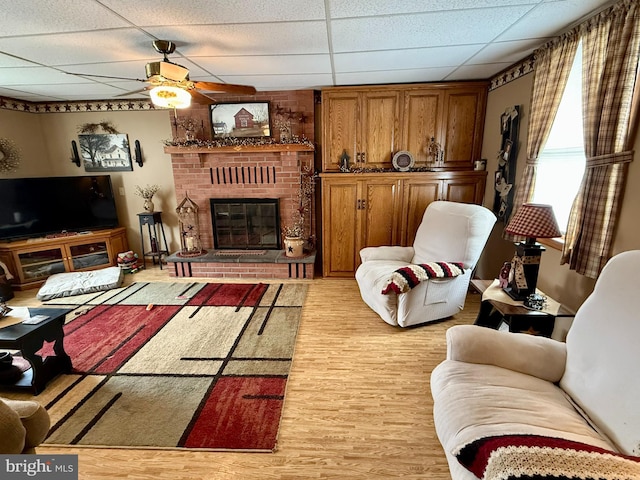 239 S Allison St, Greencastle, PA 17225 - living room with a paneled ceiling, light wood-type flooring, ceiling fan, and a fireplace